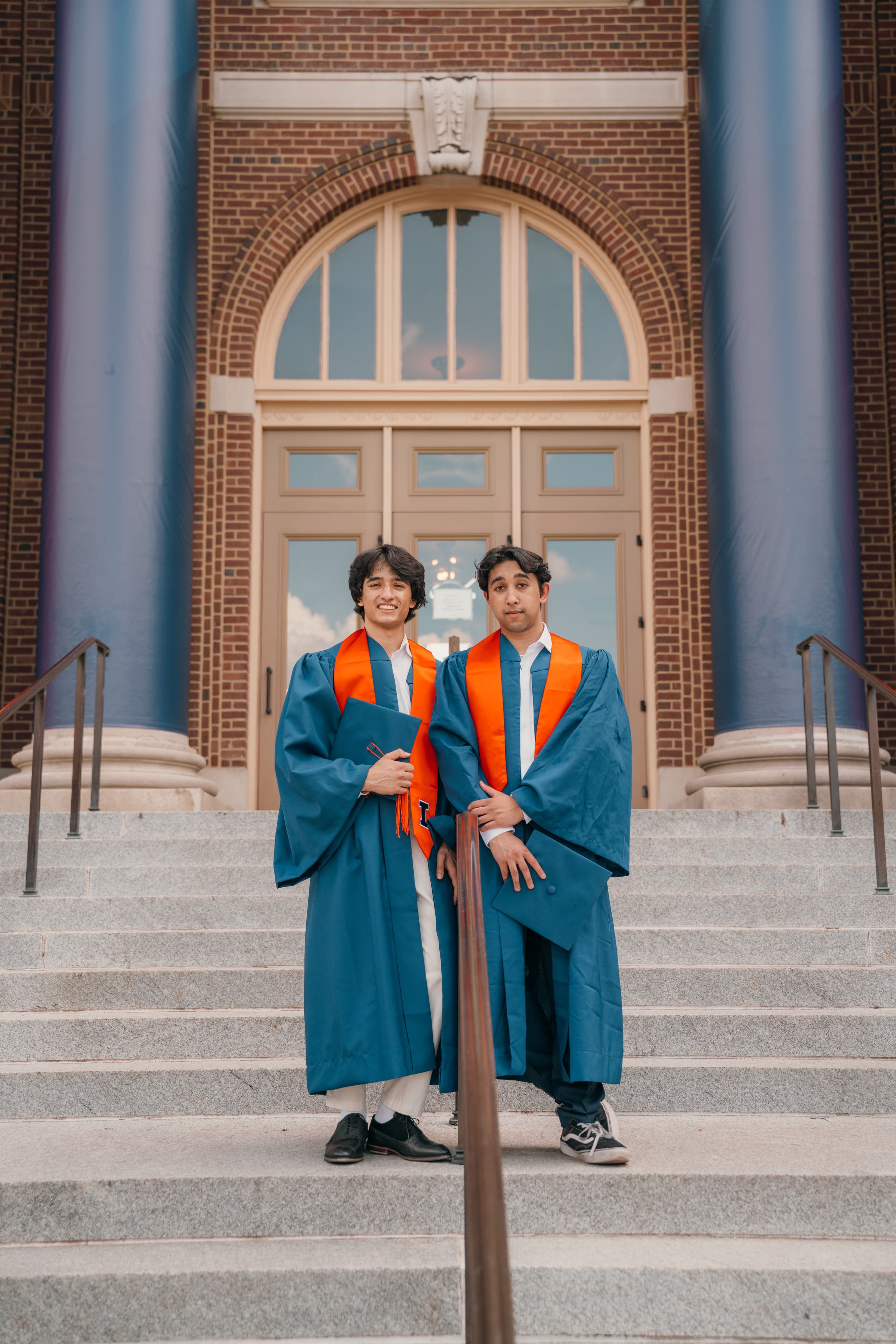 Graduate posing on campus